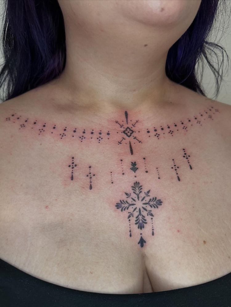 Ornamental chest tattoo by June